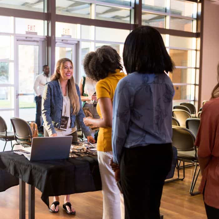 Woman working at holistic fair reception